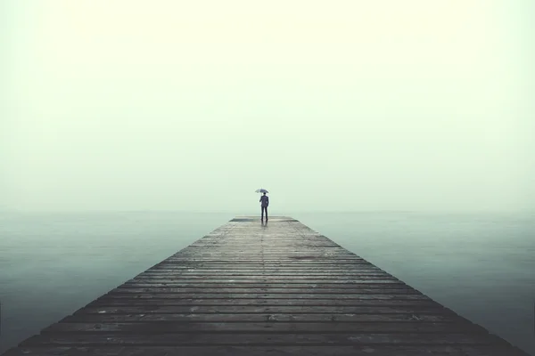 Sad business man with umbrella looking at the horizon — Stock Photo, Image