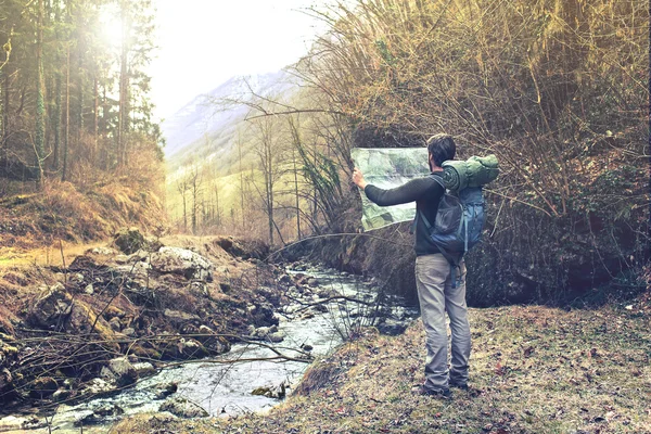 Hombre perdido observando mapa para encontrar el camino correcto — Foto de Stock