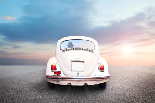 Man driving fast on the road on a white car at sunset — Stock Photo, Image