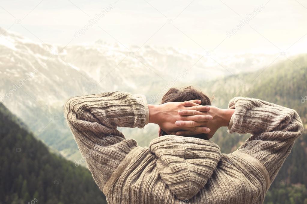 Relaxed man observing majestic mountain