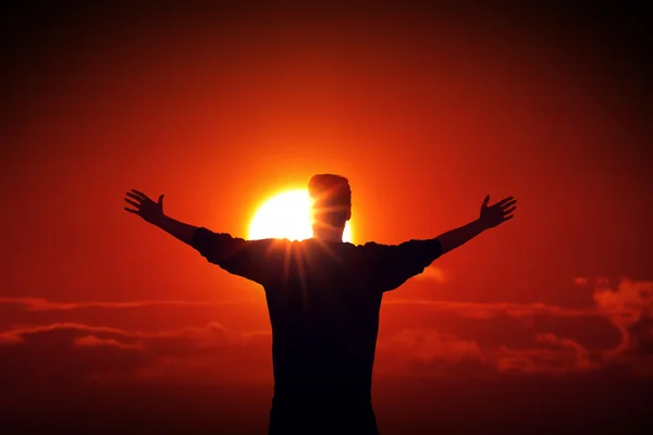 Man facing the sun finding power source — Stock Photo, Image