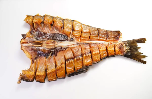 cold-smoked silver carp fish on a white background. salty snacks to beer.
