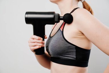 woman holds a massage gun. medical-sports device.  clipart