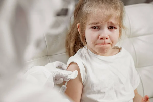 Little girl cries her hurt and scared. injection. Vaccination.