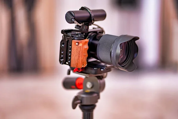 video camera on a tripod. wooden handle. professional shooting.
