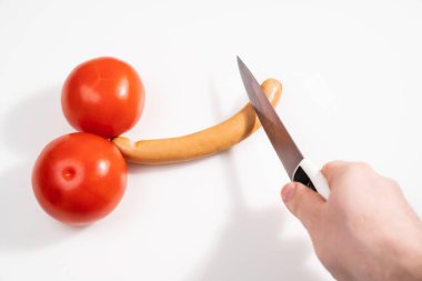 tomatoes and sausage in form of male penis on white background. Circumcision