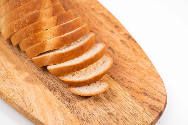Pokrojony na kawałki chleba na drewnianej desce do krojenia. — Zdjęcie stockowe