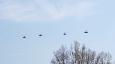 Askeri helikopterler mavi gökyüzünde uçar. Hava gösterisi.