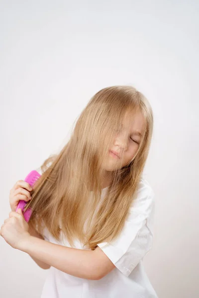 Little Girl Combs Long Tangled Hair White Background Cosmetics Care — Stock Photo, Image