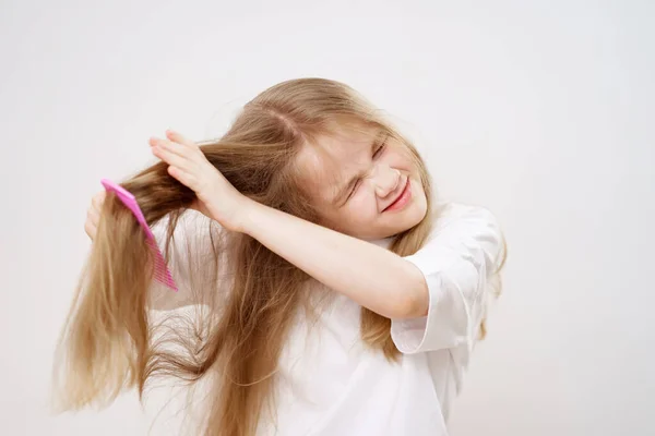 Little Girl Combs Tangled Hair White Background Cosmetics Care Children — Stock Photo, Image