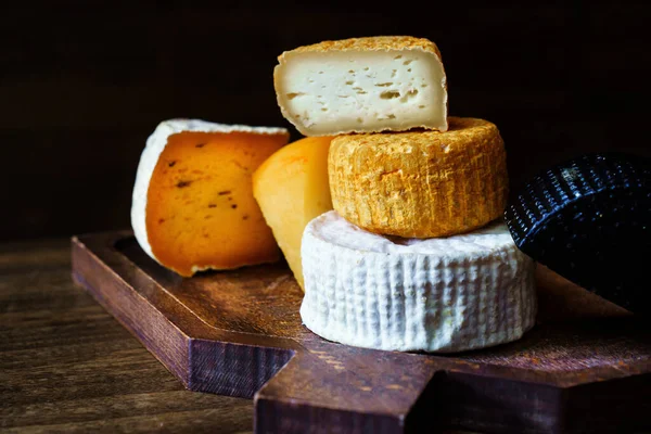 Cabeças Queijo Variadas Uma Tábua Corte Uma Mesa Madeira Fábrica Imagem De Stock