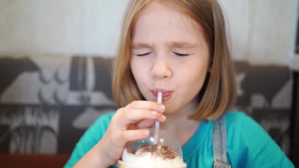 有趣的小女孩通过咖啡店的管子喝冷饮 儿童菜单 奶昔和苏打水婴儿食品 — 图库视频影像