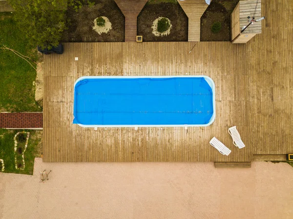 top view. pool covered with film. care of outdoor pools. recreational area. preparation for summer.