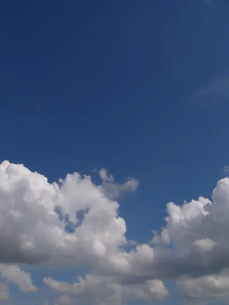 Nuvens brancas fofas no céu azul — Fotografia de Stock