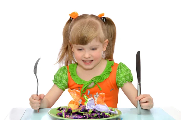 Маленька дівчинка їсть цукерки Стокове Фото