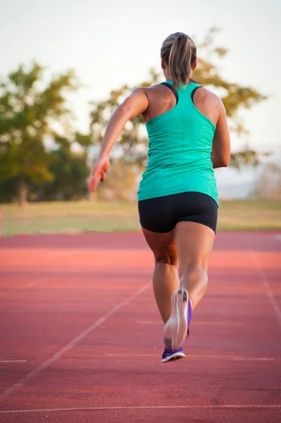 Female runner on an athletics track — Stock Photo, Image