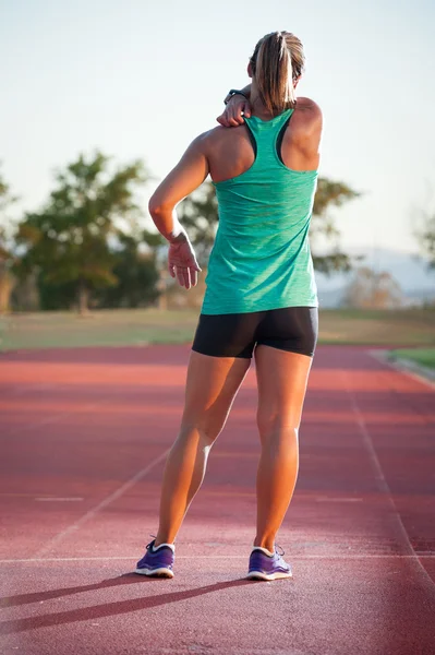 Corredor feminino em uma pista de atletismo — Fotografia de Stock