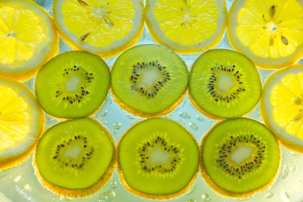 Background of fruit in water with bubbles — Stock Photo, Image