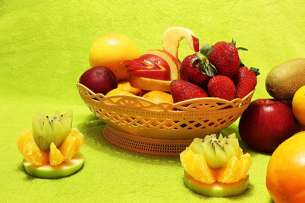 Fruits in a basket on a light green background