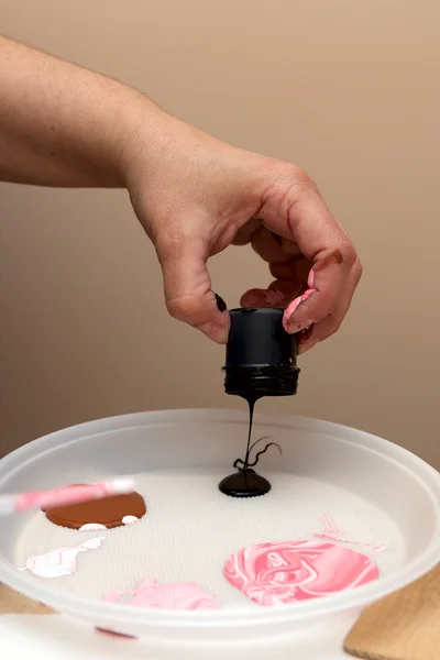 pouring paint on the palette