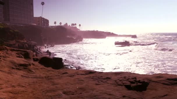 Волны разбиваются о скалы и пляж в Сан-Диего — стоковое видео