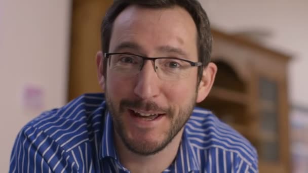 Happy man having a video chat, as seen from the point of view of a computer scre — Stock Video