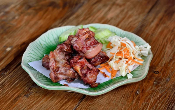 Fried sparerib on the wooden background — Stock Photo, Image