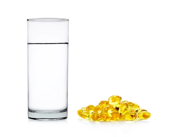 Water of glass with fish oil capsules isolated on the white back — Stock Photo, Image