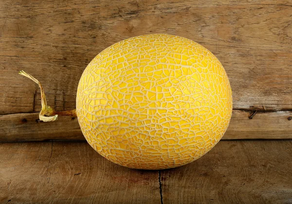 Yellow cantaloupe melon on the wooden background