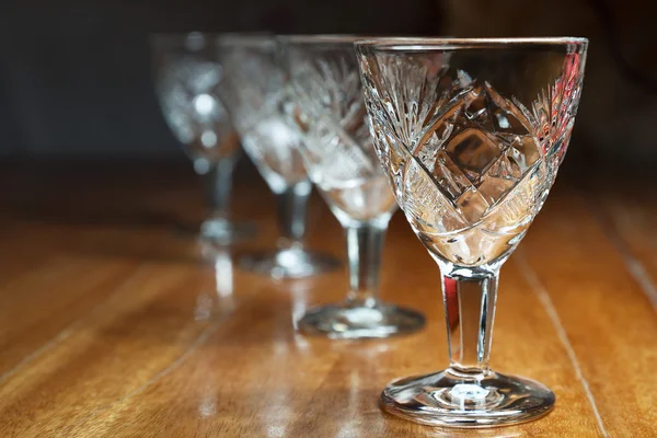 Several empty crystal glasses standing in a row — Stock Photo, Image