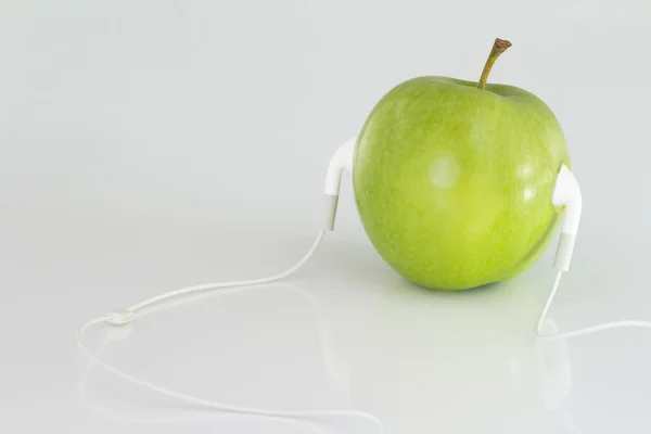 Close up Conceptual Green Apple with Headset — Stock Photo, Image