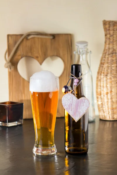 Pint of frothy beer with a heart — Stock Photo, Image