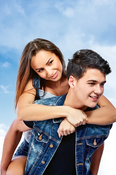 Młoda para w miłości uśmiechający się pod błękitne niebo. — Zdjęcie stockowe