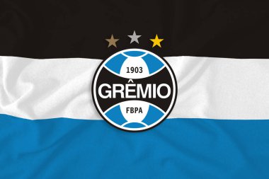 Renkli bayrağın üzerindeki GRMIO logosu. Brezilya Futbol Takımı