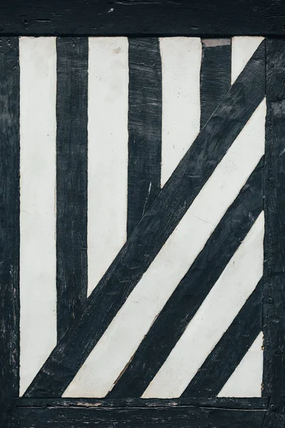 Ahşap ve taş duvar zemininde siyah tahta kirişler var.