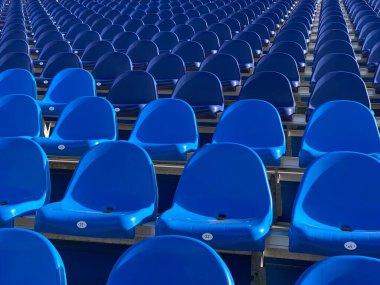 Boş mavi stadyum koltuğu güzel bir perspektifte destekçileri bekliyor.