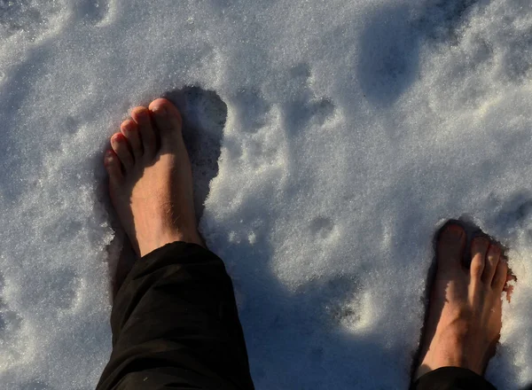 walking through the snow without boots. First take off your socks and then come across the snow cover. The legs are perfused and burning strongly. it is healthy