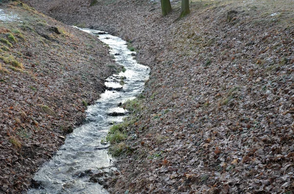 flooded stream led to a narrow riverbed where the water drains quickly, the bends must be laid out with a stone so that water erosion does not damage them, the water pipeline supplies water in winter