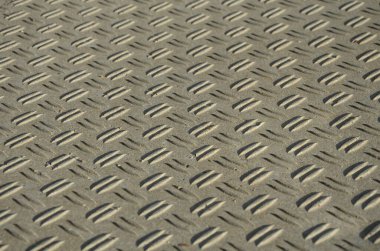 concrete monolith staircase with the texture of extruded ribbed, corrugated sheet metal. ramp with vegetation of ornamental dry grasses and perennials tin edge curb