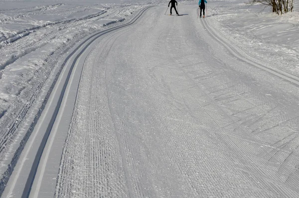 start of the cross country skiing route. The tracks are prepared by a snowmobile with special attachments for pushing the track in the shape of tracks. Cross country skiers like to use them for riding