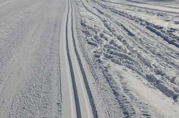 start of the cross country skiing route. The tracks are prepared by a snowmobile with special attachments for pushing the track in the shape of tracks. Cross country skiers like to use them for riding
