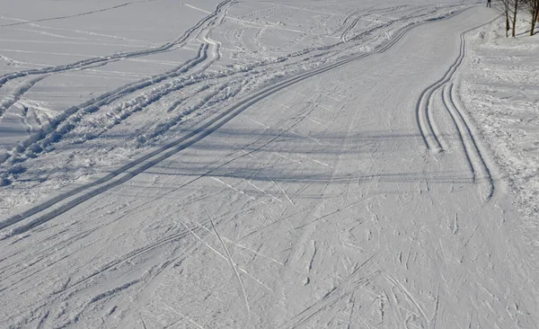 start of the cross country skiing route. The tracks are prepared by a snowmobile with special attachments for pushing the track in the shape of tracks. Cross country skiers like to use them for riding