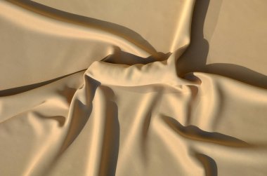 male cock under a satin sheet in bed. it is a gift for a partner bought in a sex shop. the picker or dildo is tastefully arranged with police handcuffs for play in the bedroom bed