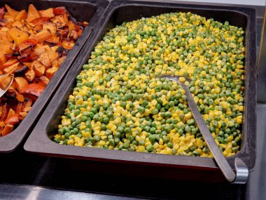 Çeşitli türde kızarmış sebzelerle açık büfe. Kızarmış tatlı patates küpü. Kızarmış sebze, kabak, biber ve patlıcan. Mısır karışımı. Bezelye. Tatlı patatesler tatlı ve antioksidan açısından zengindir..