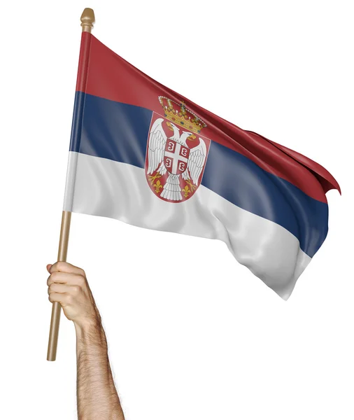 Hand stolt viftar den nationella flaggan i Serbien — Stockfoto