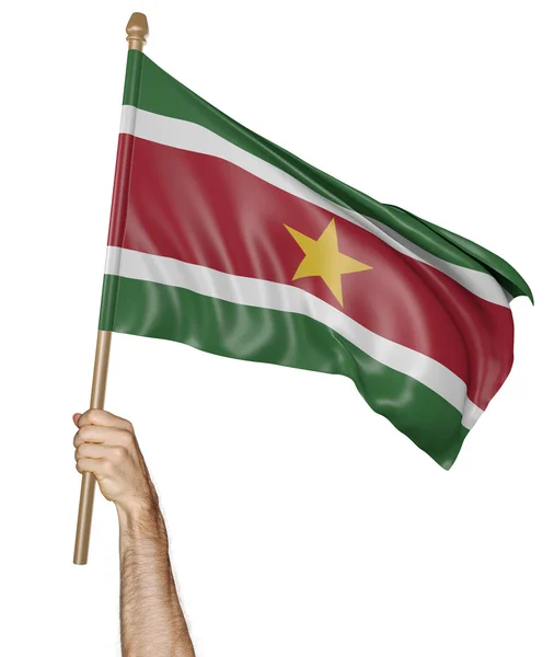 Mano orgullosamente ondeando la bandera nacional de Surinam —  Fotos de Stock