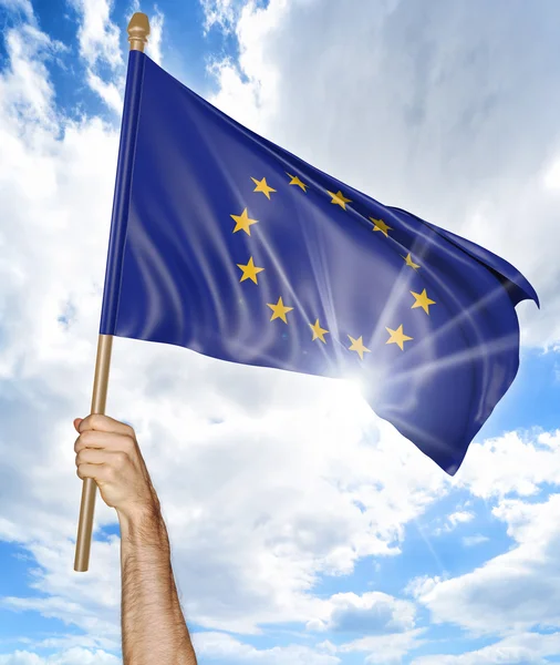 Person 's hand holding the European Union flag and waving it in the sky, 3D rendering — стоковое фото