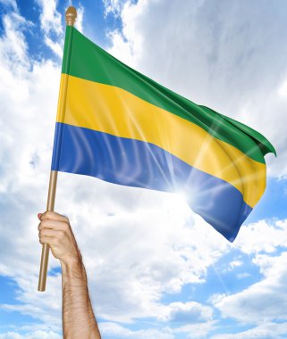 Gabon ulusal bayrak tutan ve gökyüzü, 3d render sallayarak birinin elini