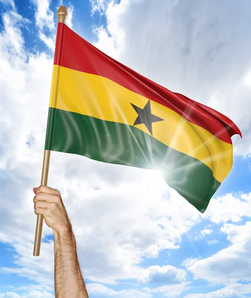 Mano de la persona sosteniendo la bandera nacional de Ghana y agitándola en el cielo, representación 3D —  Fotos de Stock
