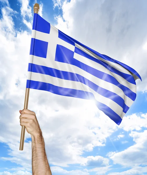 Person 's hand holding the Greek national flag and waving it in the sky, 3D rendering — стоковое фото